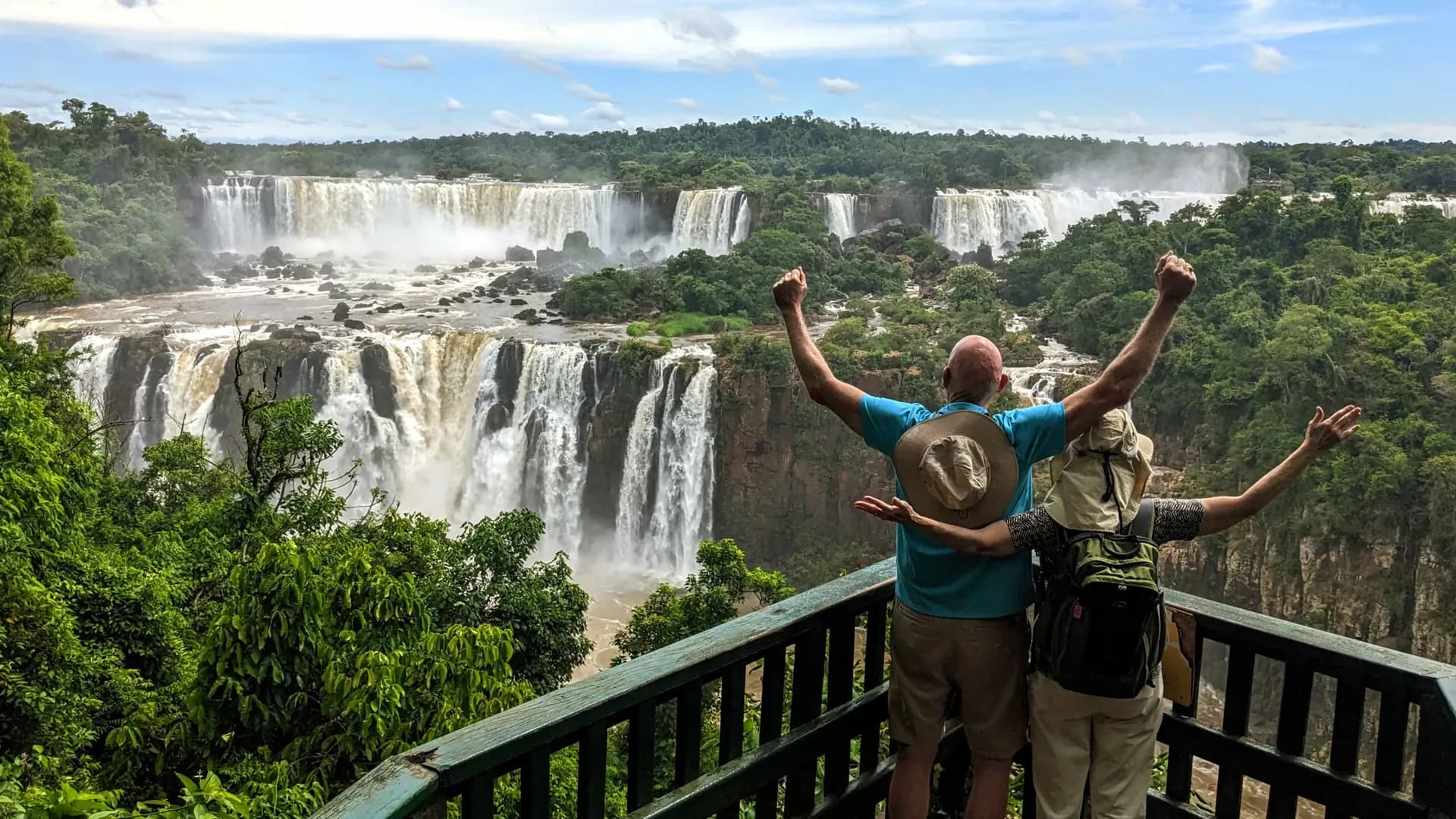 Panoramic view of Iguazú Falls' many cascades framed by rainforest