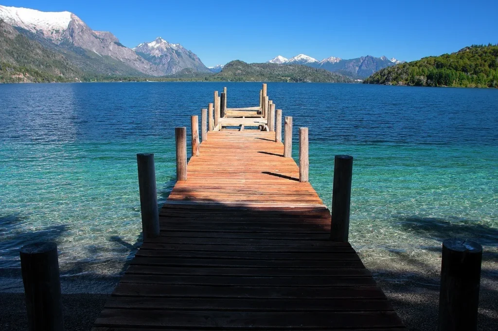 The pristine crystal-clear turquoise waters of Lago Moreno surrounded by forests