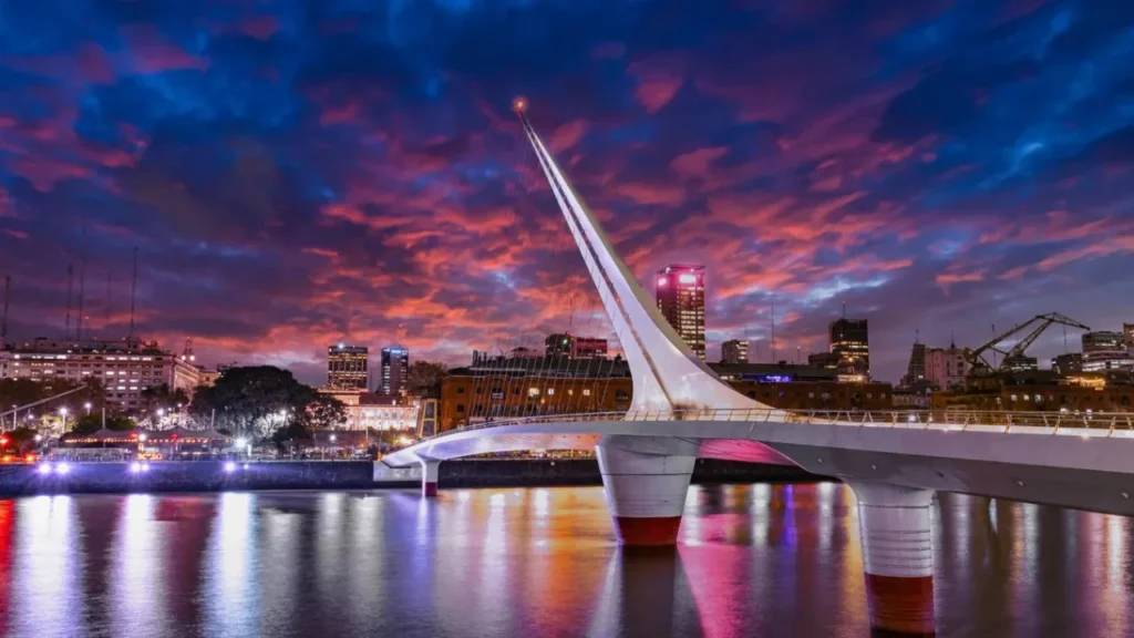 Illuminated Puente de la Mujer bridge in Puerto Madero district at twilight