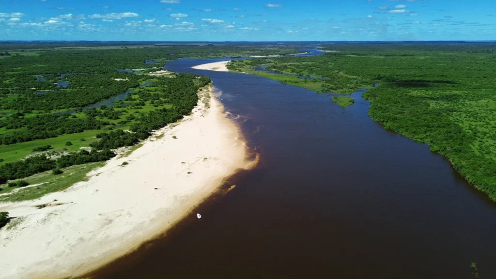Aerial panoramic view of the Corrientes river wetlands showing white sand banks and lush vegetation