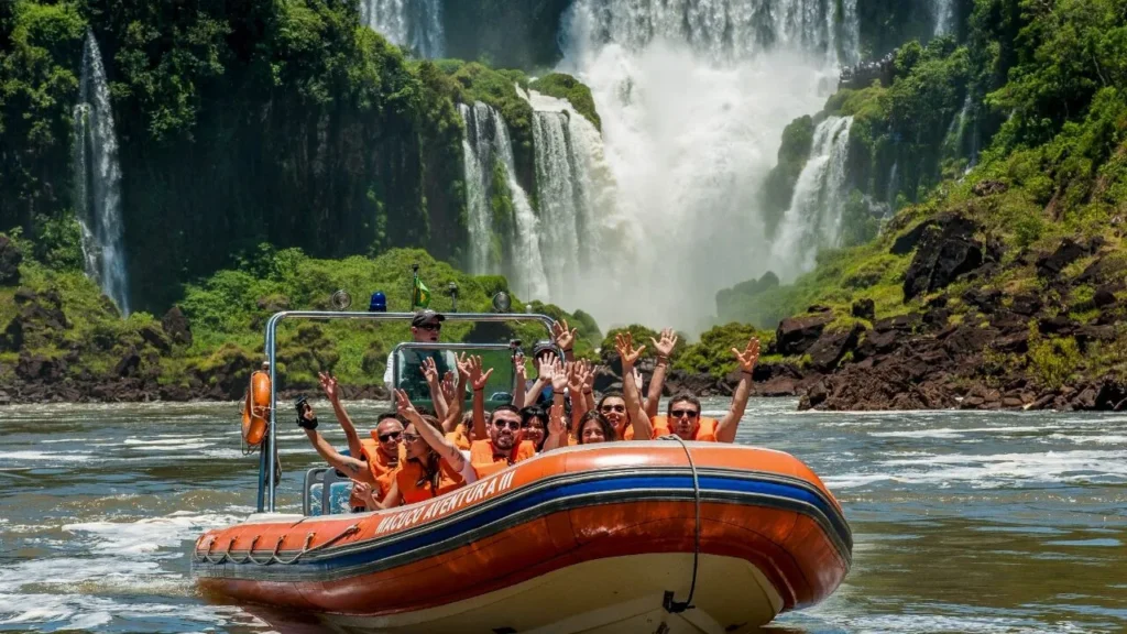 Comfortable wicker sofas on a luxury lodge terrace with a stunning backdrop of the Iguazu Falls